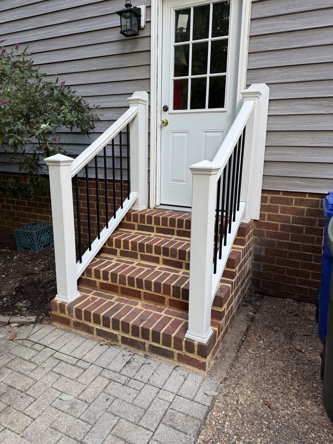 Finished railing at a brick entry stair