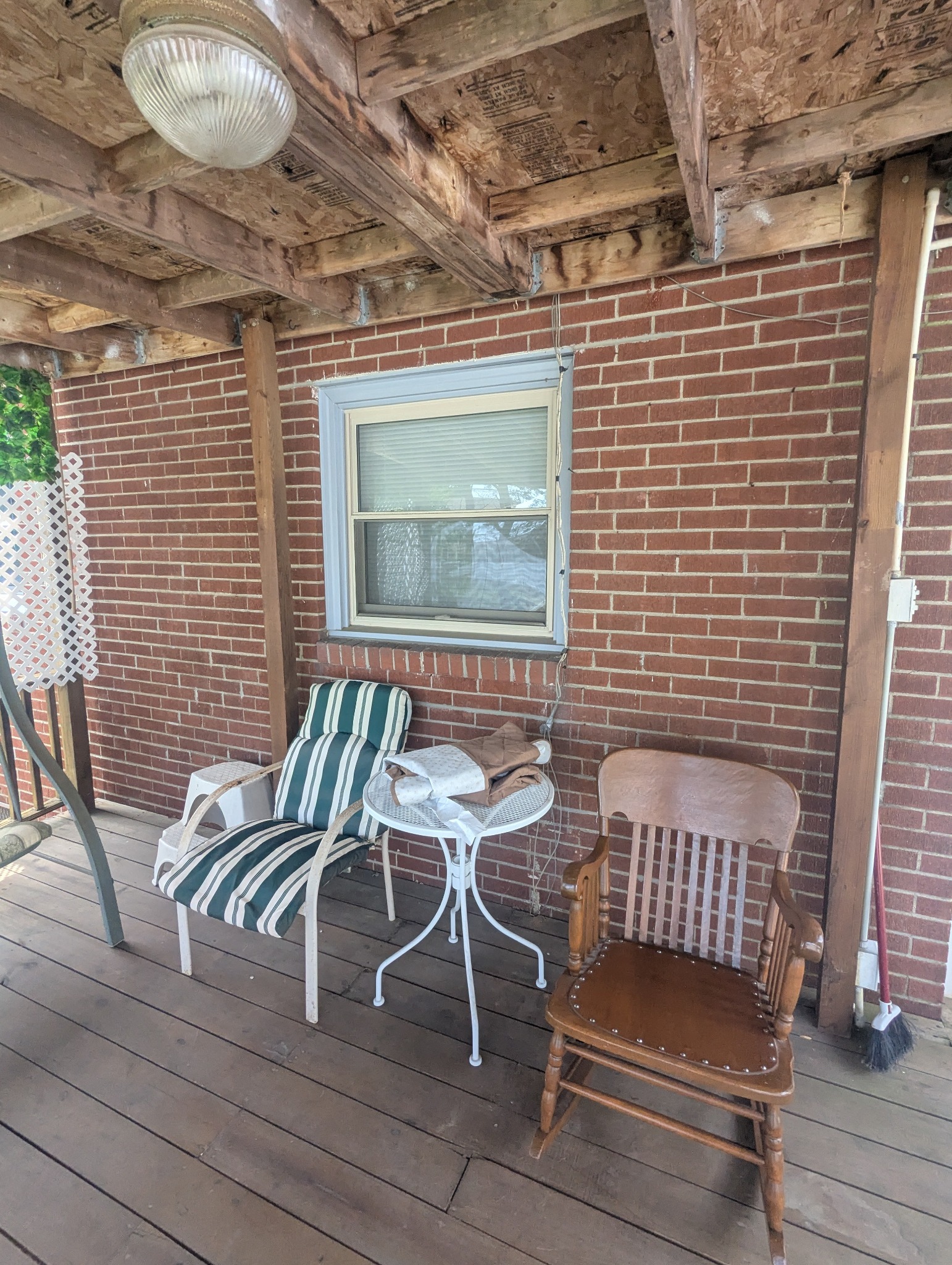 Brick exterior wall with a window before conversion to French doors